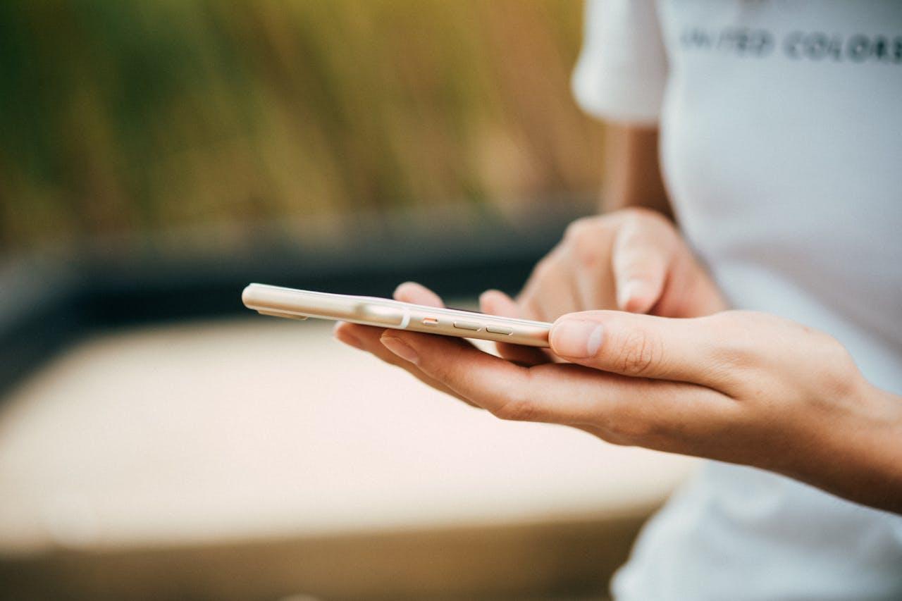 Image of hands holding an iphone