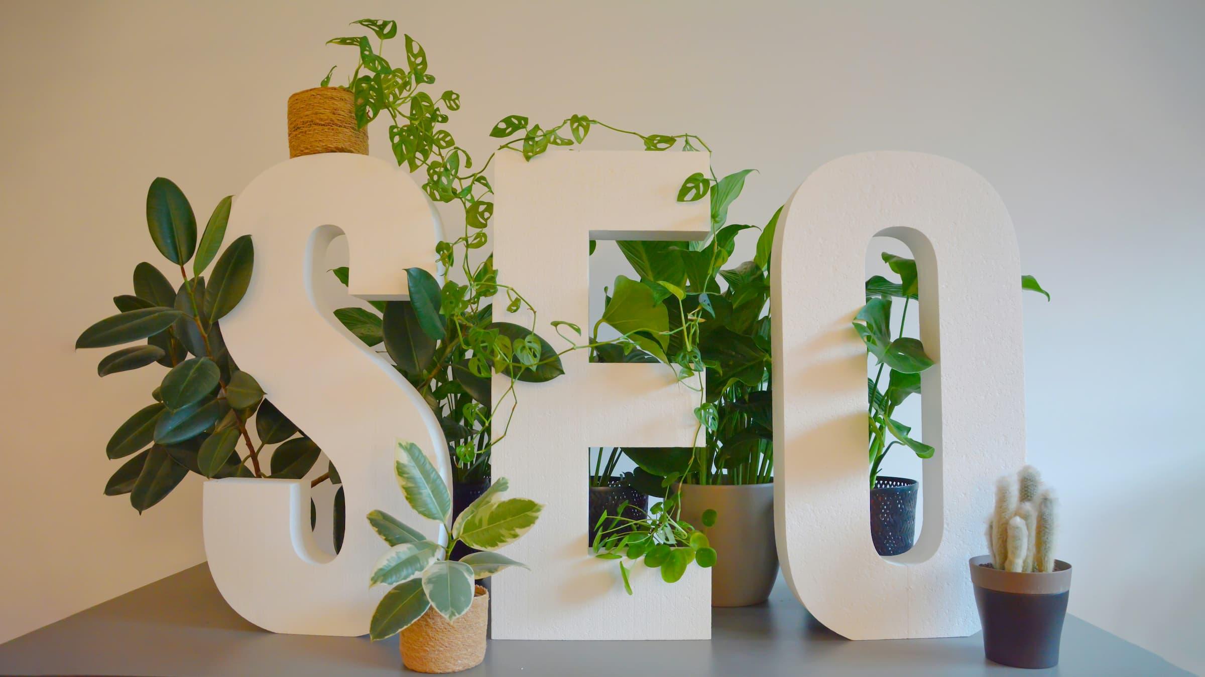 Large 'SEO' letters prominently displayed on a modern desk.