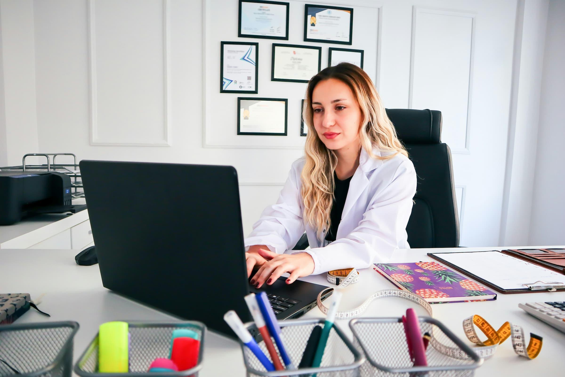 Female doctor using a laptop.